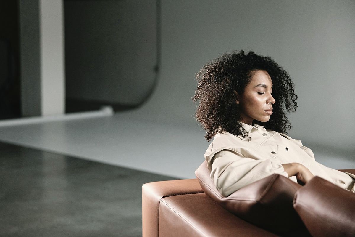 A woman resting in a calm, softly lit room